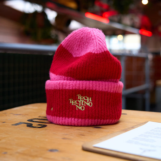 TECHNO HEART Beanie, Rave, Festival Cosy Unisex Hat, by Hun Sauce. pink and red with green stitching. Now stocked at All My Friends Record Store, Hackney Wick.