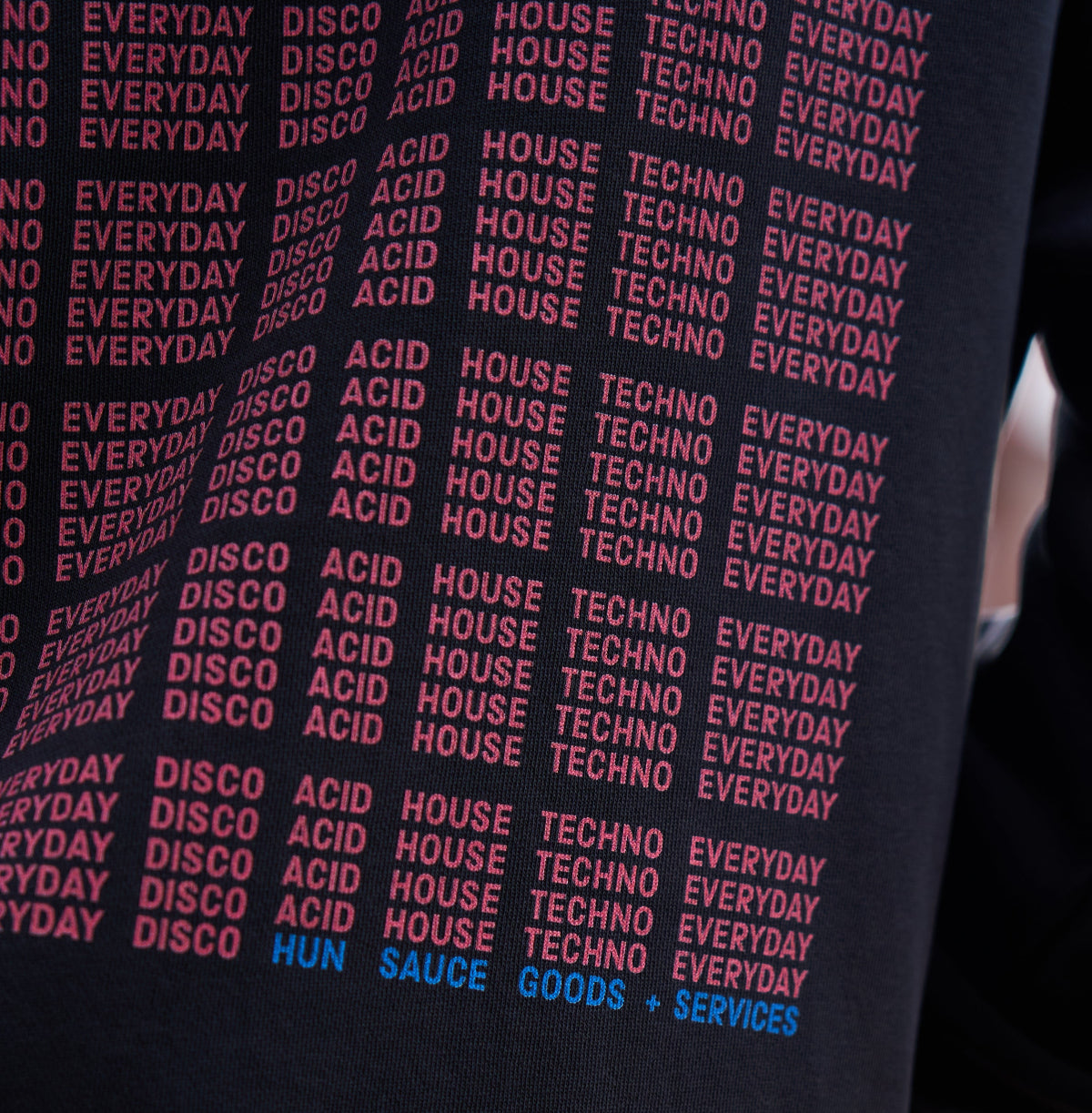 Model in I'M NOT A DJ Hoodie - Hun Sauce, Black hood for DJs. I'm not disc jockey collection for the rave. Heavyweight hood. Now available at the record store at All My Friends, in Hackney.