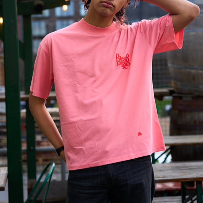 DISCO HEART Heavyweight T-Shirt, Disco Fans Heart Red Graphic on oversized pink tee, by Hun Sauce. Model Shot at All My Friends Hackney Wick. Now available in the record store.