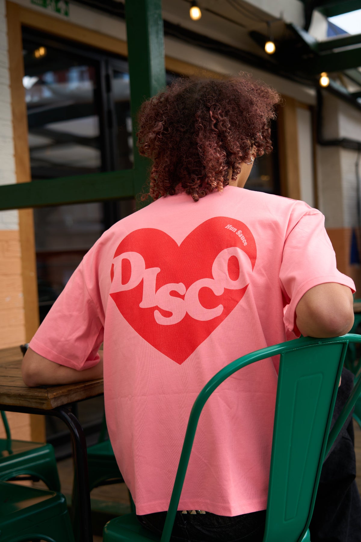 DISCO HEART Heavyweight T-Shirt, Disco Fans Heart Red Graphic on oversized pink tee, by Hun Sauce. Model Shot at All My Friends Hackney Wick. Now available in the record store.