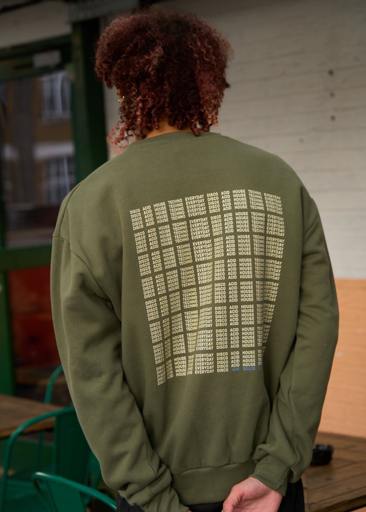 Model wears I'M NOT A DJ Heavyweight Sweater, Rave Streetwear, Graphic DJ Sweat, By Hun Sauce. Independent streetwear brand. Now stocked at All My Friends, store, Hackney Wick.