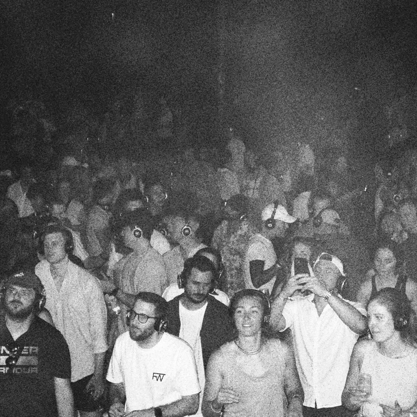 DJ Fernweh's crowd wearing custom Hun Sauce white T-shirt with cleaned-up logo and embroidered caps featuring a remix of the Hun Sauce smiley, photographed at Weinfestival Koblenz by Luca Di Stefano.